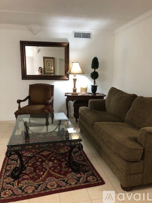A living room with a couch, chair, and table.