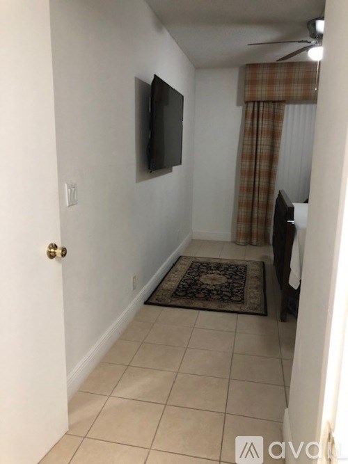 A room with a flat screen TV mounted on the wall.