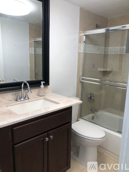 A bathroom with a sink, toilet, and shower.