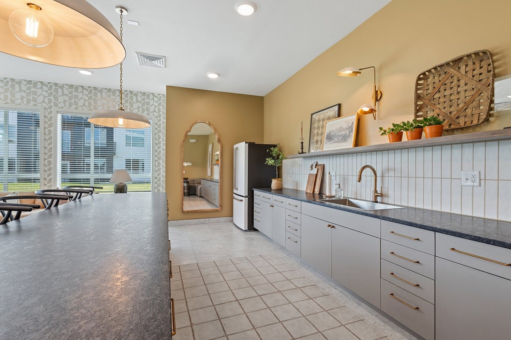 A kitchen with a large island and a dining table.