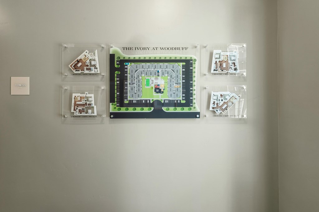 A wall with a map and four other pictures on it.