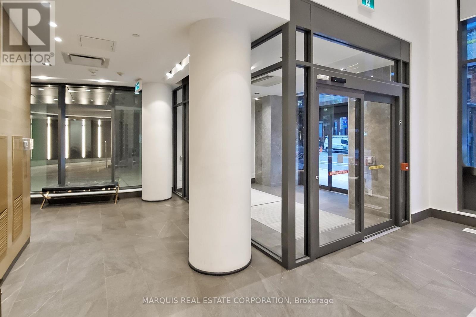A glass door entrance to a building with a sign that says "REALTOR".