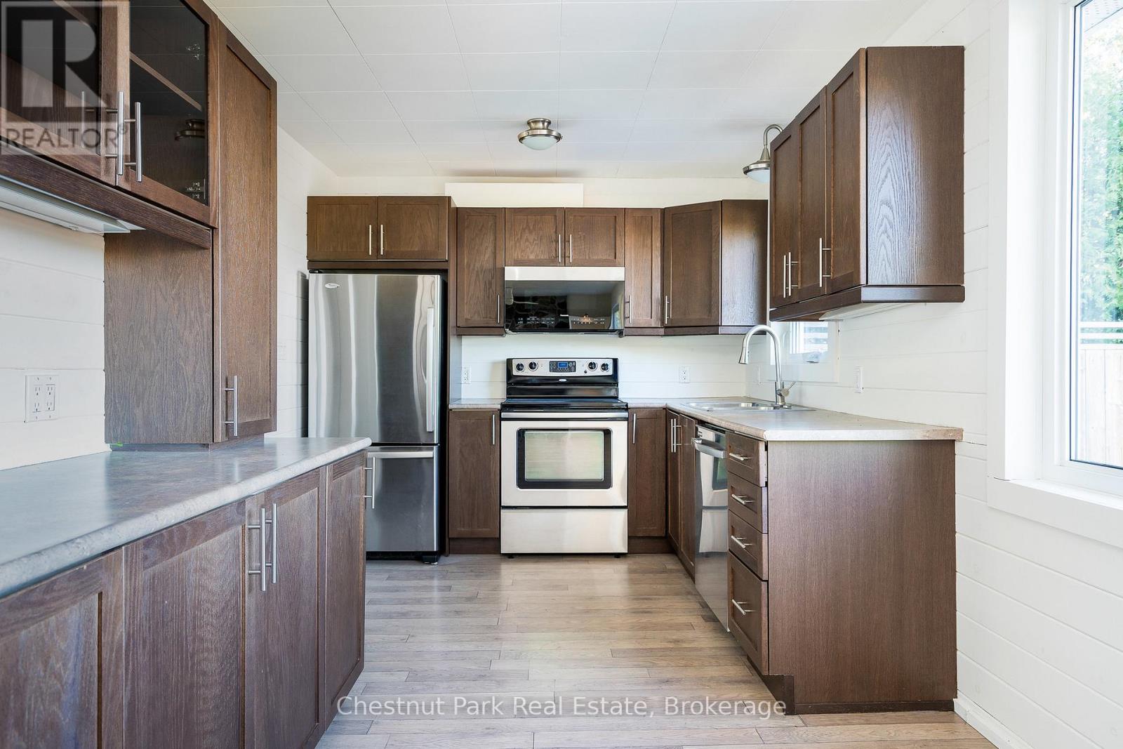 A kitchen with wooden cabinets and stainless steel appliances.