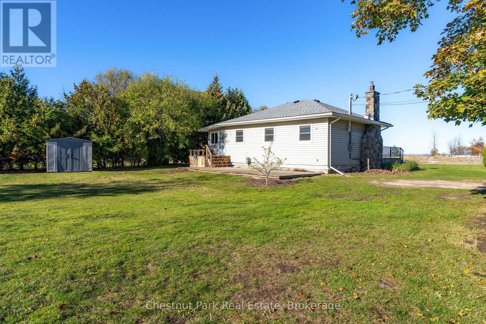 A house with a large lawn in front of it.