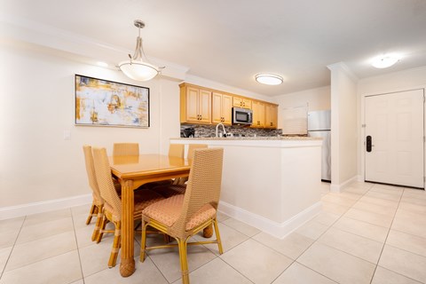 A kitchen with a table and chairs.