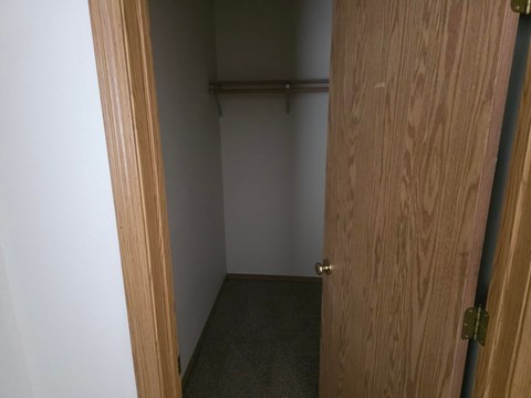 A small, empty room with a wooden door.