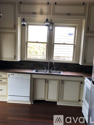A kitchen with a white dishwasher and a sink.