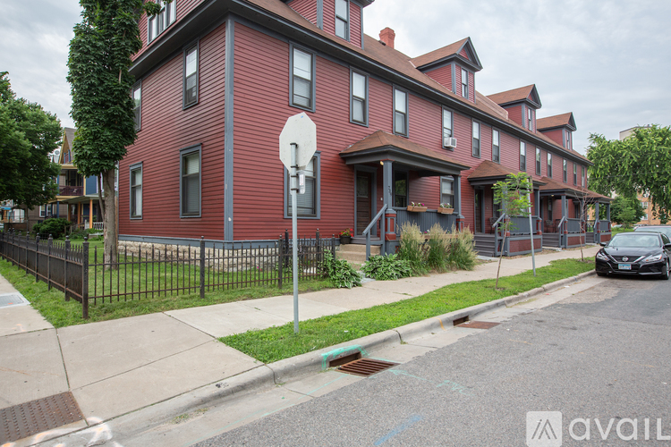A red brick building with a basketball hoop in front.