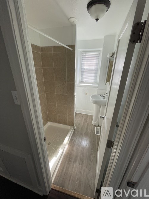 A bathroom with a walk in shower and a toilet.