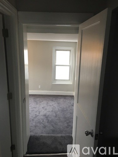 A white door with a window in the room.