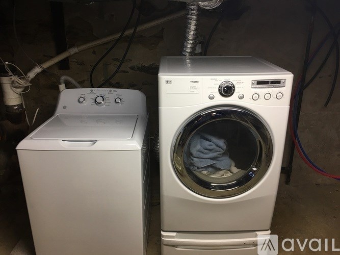 A washing machine is placed next to a dryer.