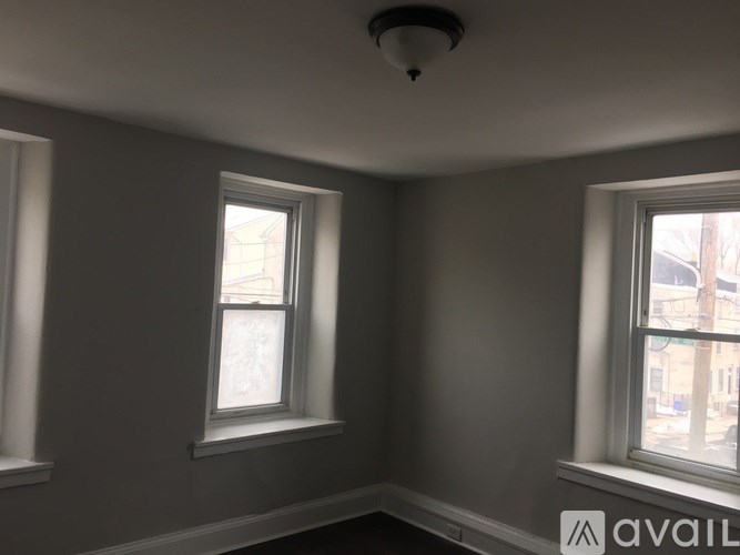 A room with two windows and a ceiling light.