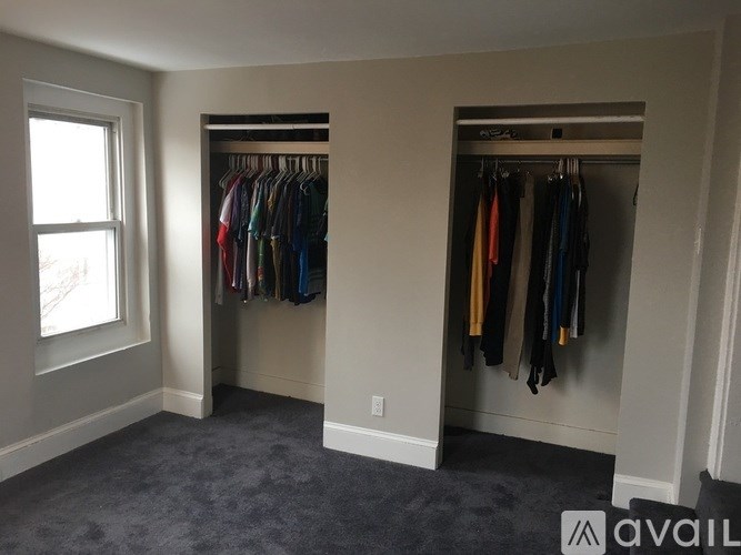 A room with a closet and a window.