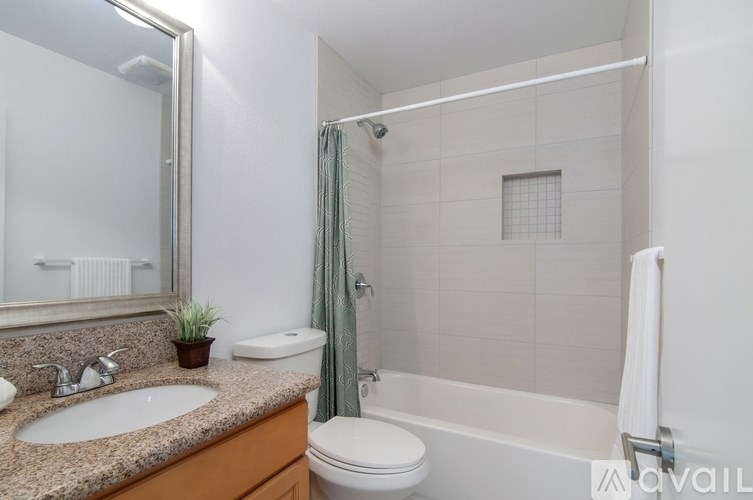 A bathroom with a toilet, sink, and bathtub.
