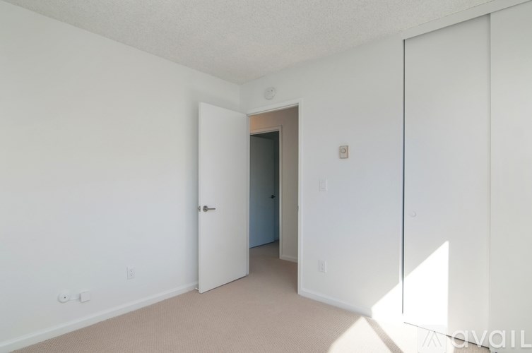 A room with a white door and a white wall.