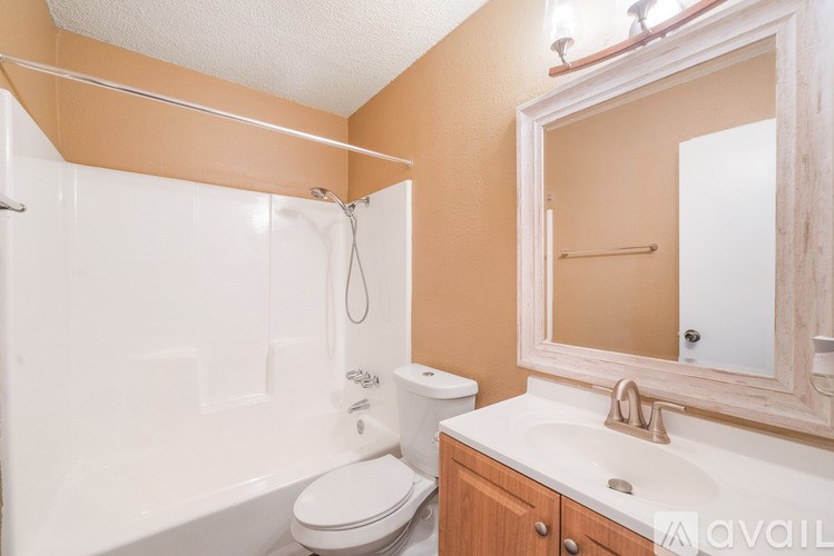 A bathroom with a toilet, sink, and bathtub.