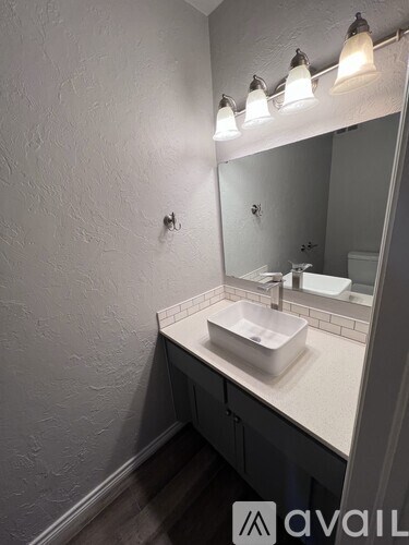 A bathroom with a sink and mirror.