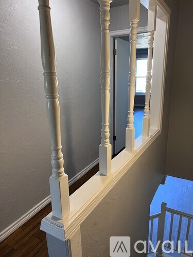 A white balustrade with a blue carpeted floor.