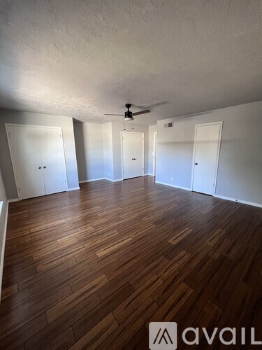A room with wooden floors and white walls.