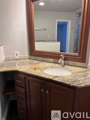 A bathroom with a sink and a mirror.