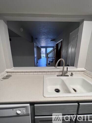 A white sink with a silver faucet in a bathroom.