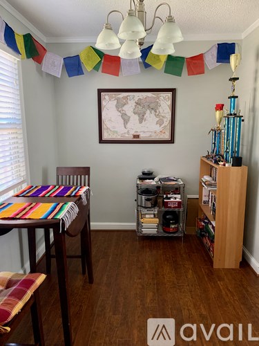 A room with a table, chairs and a world map on the wall.