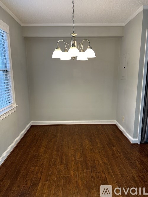 A kitchen with a fridge covered in magnets, a microwave, and an oven.