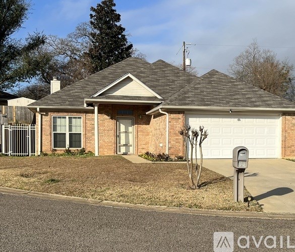 A house with a garage door and a mailbox in front.