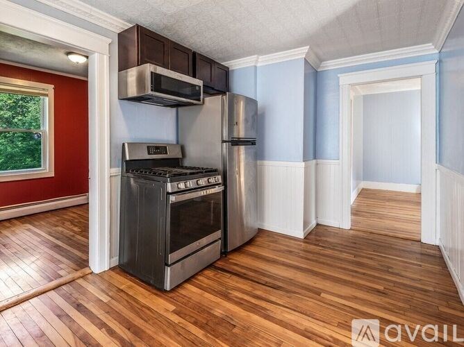 A kitchen with a stove top oven and a microwave above it.