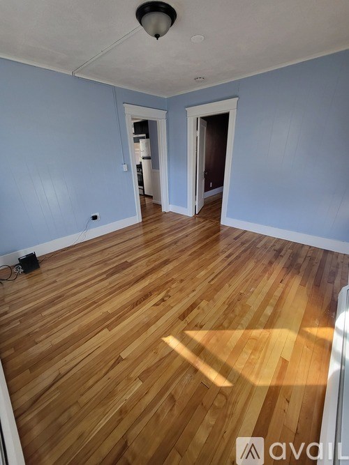 A room with wooden floors and blue walls.