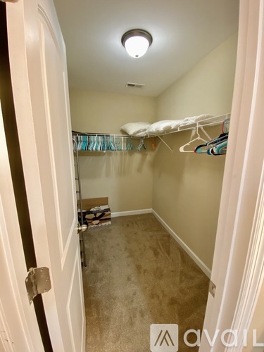 A small bedroom with a bed on the left and a closet on the right.