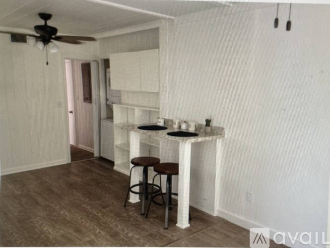 A room with a bar and stools.