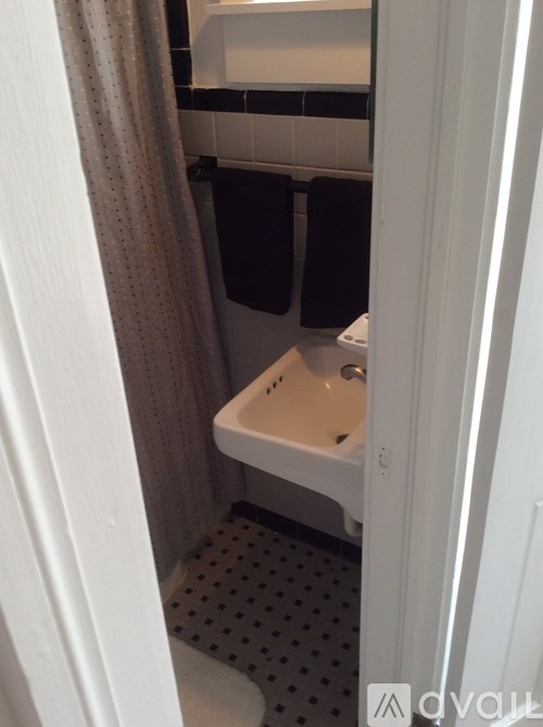 A white sink in a small bathroom.