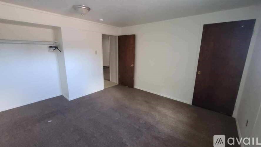 A room with a sliding door and a brown door.