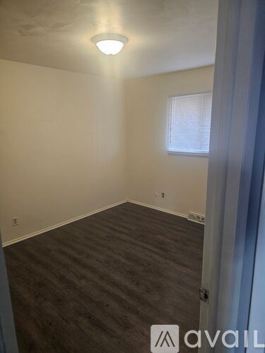 A room with a window and a door.