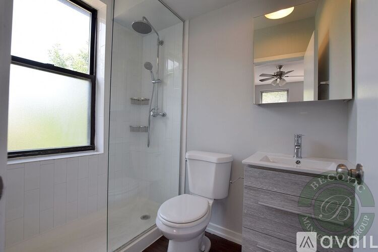 A white toilet in a bathroom with a glass shower door.