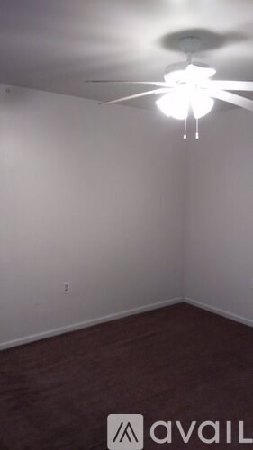 A room with a ceiling fan and a light fixture.