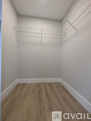Empty room with wooden floor and white walls.