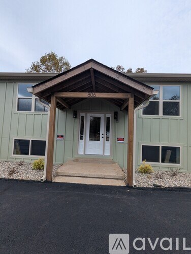 A house with a porch and a white door.