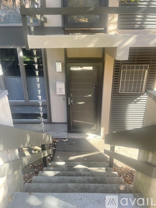 A set of stairs leading to a door with a number 76 on the wall.