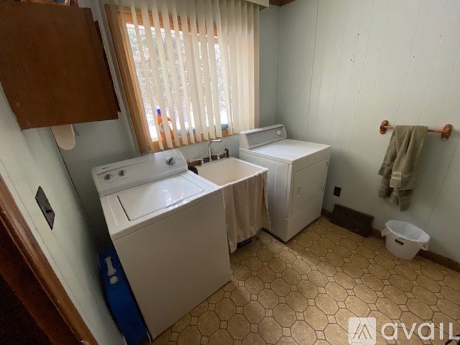 A small laundry room with a washer and dryer.