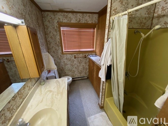 A bathroom with a sink, toilet, and bathtub.