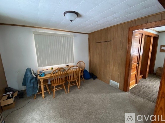 A room with a table and chairs in it.