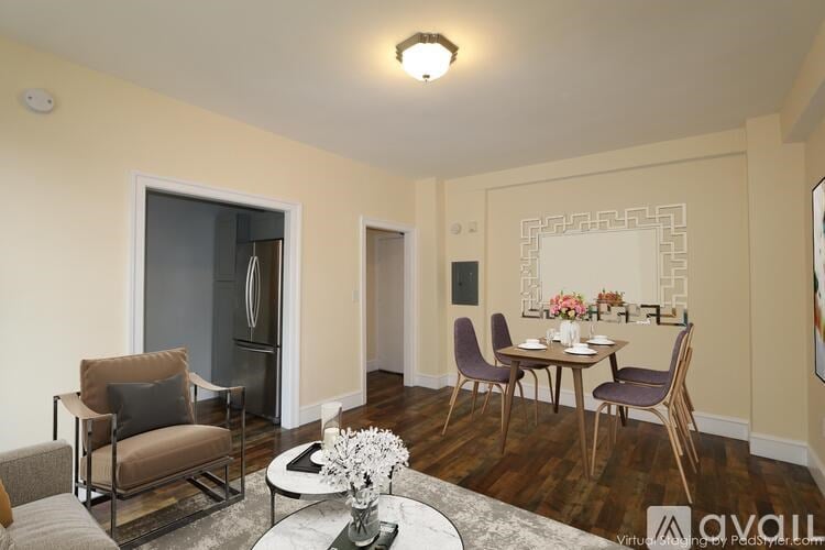A living room with a dining table set up with chairs around it.
