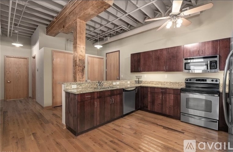 A kitchen with wooden floors and a large island in the middle.