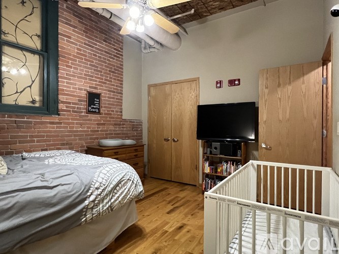 A baby's room with a crib and a bed.