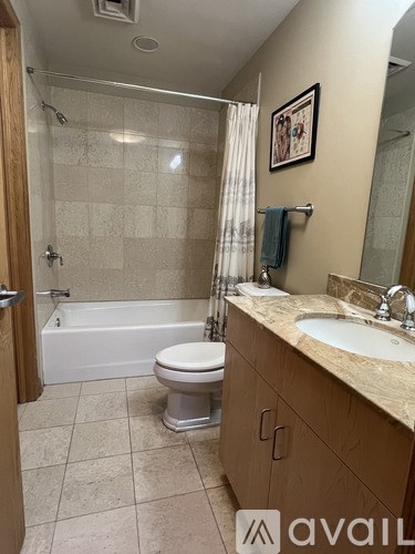 A bathroom with a toilet, sink, and bathtub.