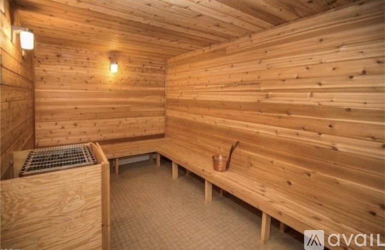 A wooden sauna with benches and lights.