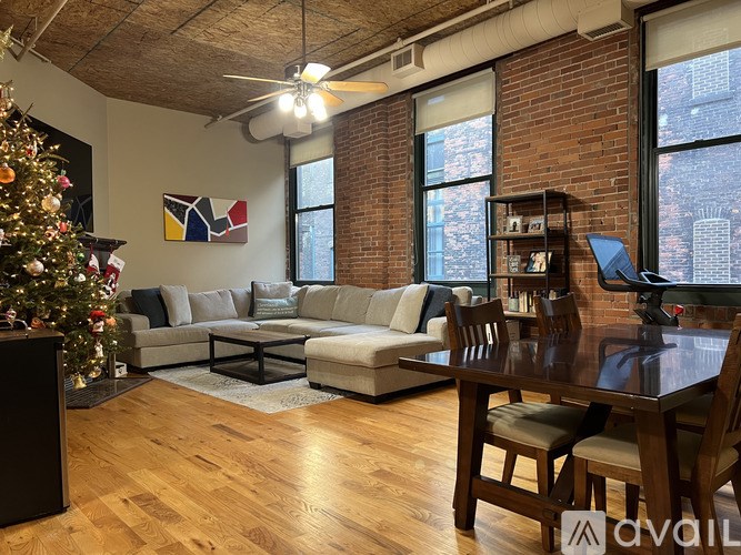 A living room with a Christmas tree and a couch.