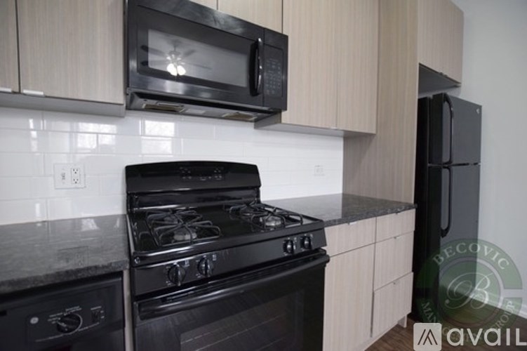 A black stove top oven with a microwave above it.